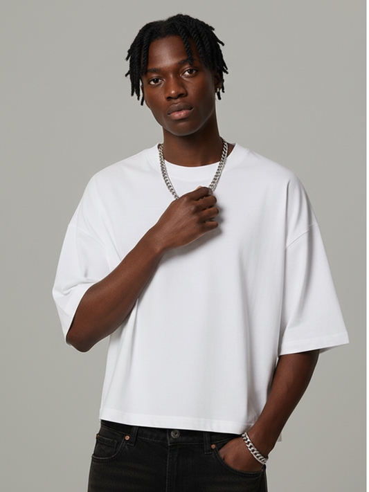 Person wearing a white t-shirt and black pants against a gray background