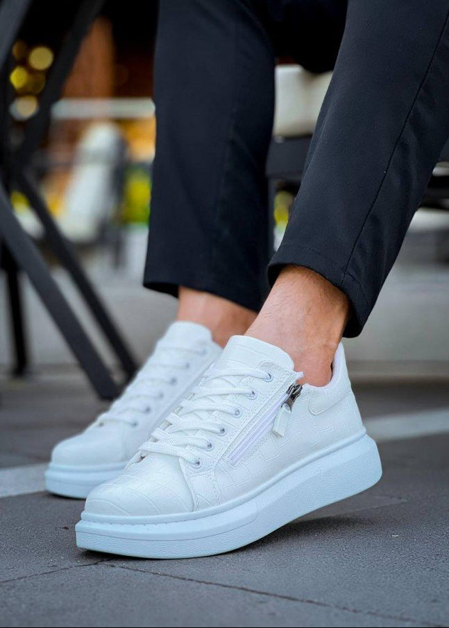 White sneakers with zippers worn by a person on a blurred background