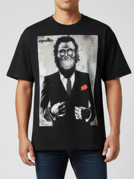 Person wearing a black t-shirt with a graphic design of a monkey in a suit on a plain background