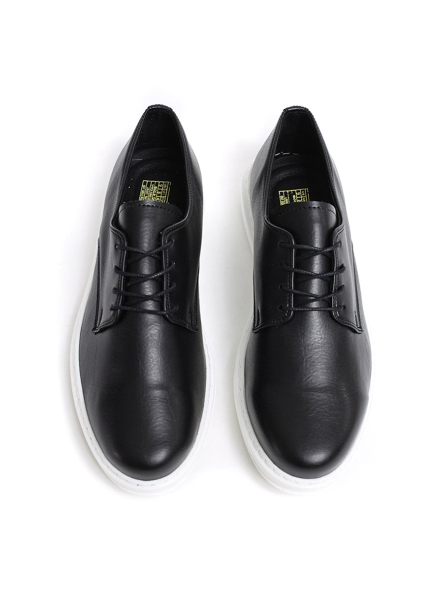 Pair of black leather shoes on a white background