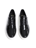 Black patent leather shoes on a white background