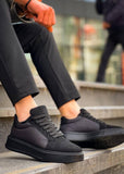 Person wearing black sneakers sitting on steps with a blurred background