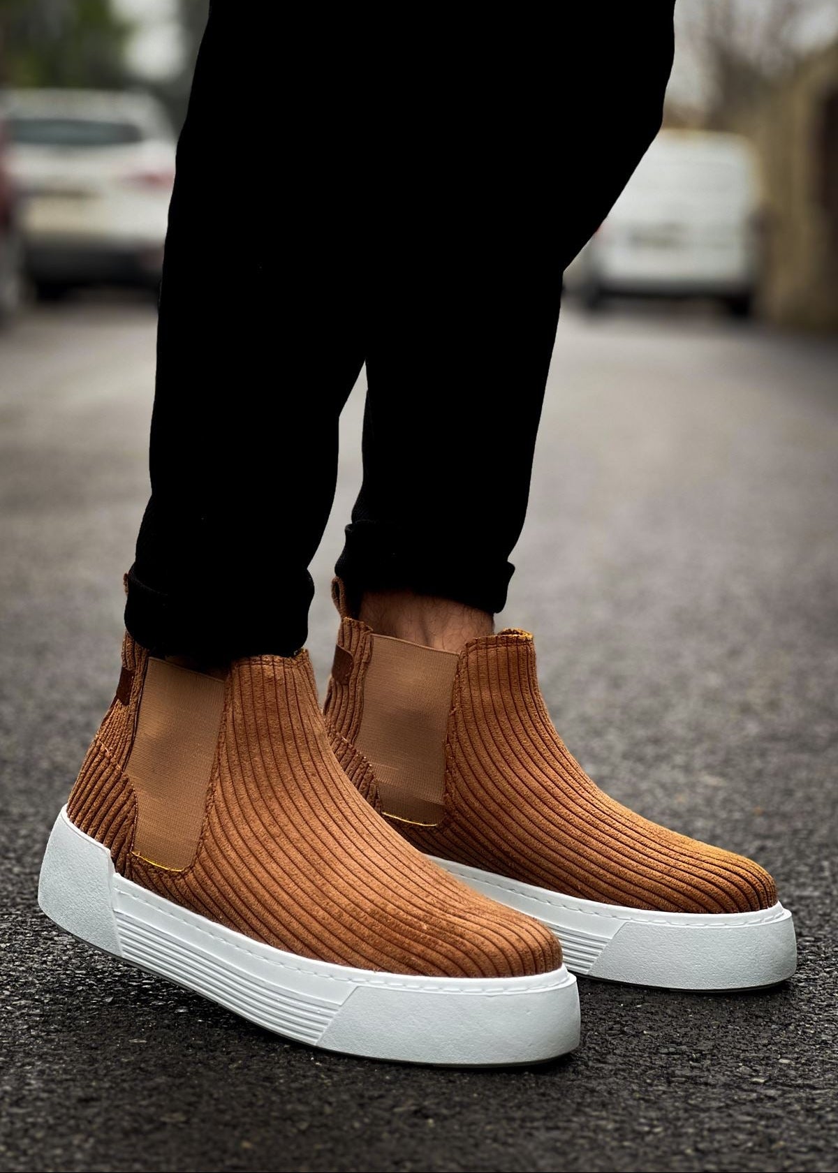 Close-up of Avalon Brown ribbed Chelsea Apollo boots with white sole worn outdoors.