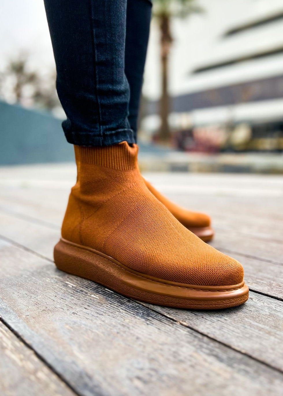 Lifestyle shot of Torino X Espresso Essence by Apollo Moda in brown knit slip-on ankle boots on city pavement