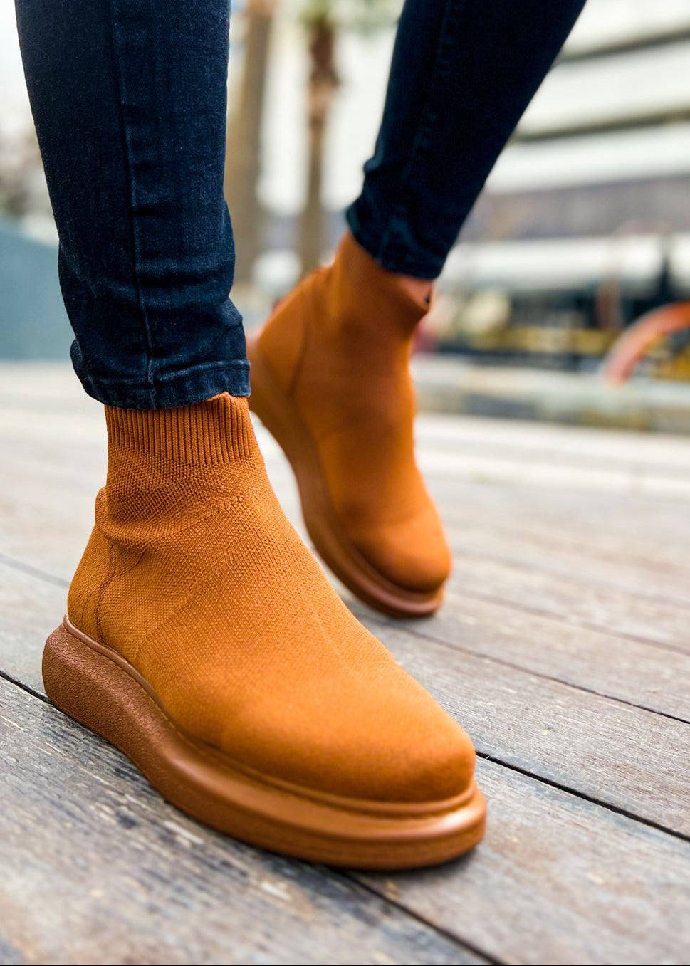 Brown ankle Apollo Moda Torino X brown boots worn with rolled-up jeans on a wooden floor.